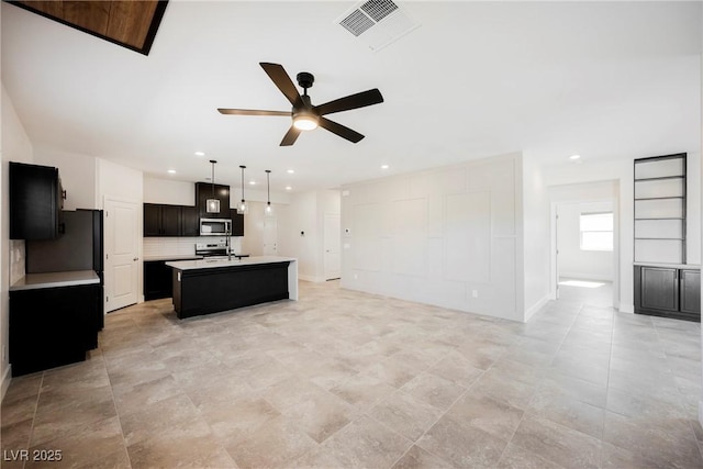 37 Late Harvest Ave, Pahrump, NV 89060 - kitchen featuring stainless steel microwave, ceiling fan, open floor plan, light countertops, and recessed lighting