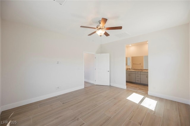 37 Late Harvest Ave, Pahrump, NV 89060 - unfurnished bedroom featuring light wood-style flooring, baseboards, connected bathroom, and ceiling fan
