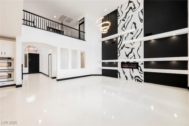 8244 Cupertino Heights Way, Las Vegas, NV 89178 - interior space with arched walkways, a towering ceiling, and a chandelier