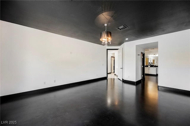 8244 Cupertino Heights Way, Las Vegas, NV 89178 - spare room with baseboards, finished concrete floors, and a chandelier