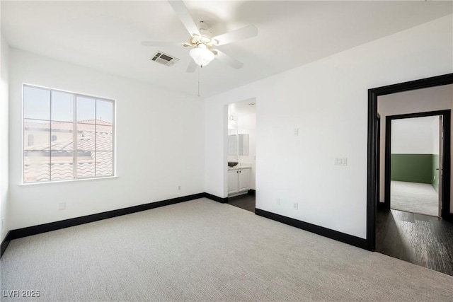8244 Cupertino Heights Way, Las Vegas, NV 89178 - unfurnished bedroom featuring baseboards, dark carpet, a ceiling fan, and connected bathroom