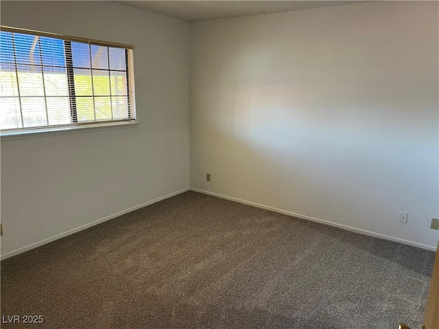 4121 Gannet Cir Unit 414, Las Vegas, NV 89103 - spare room with dark colored carpet and baseboards