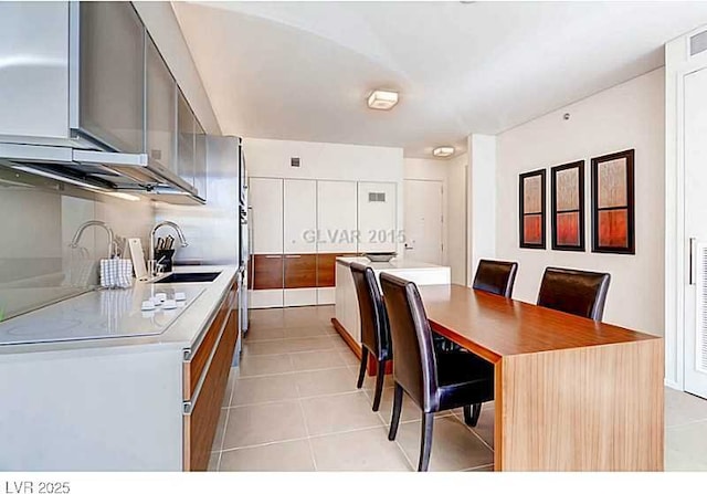 kitchen with light tile patterned floors, light countertops, and modern cabinets