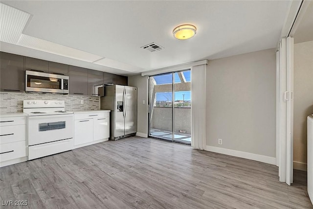 kitchen with stainless steel appliances, modern cabinets, baseboards, light countertops, and light wood-style floors