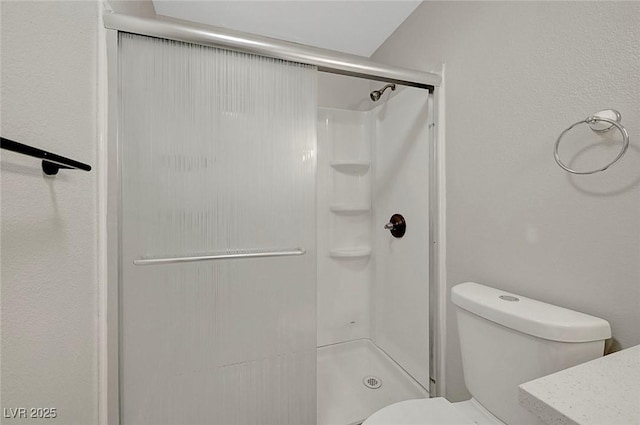 full bath with toilet and a stall shower