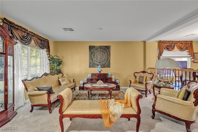 carpeted living area featuring baseboards