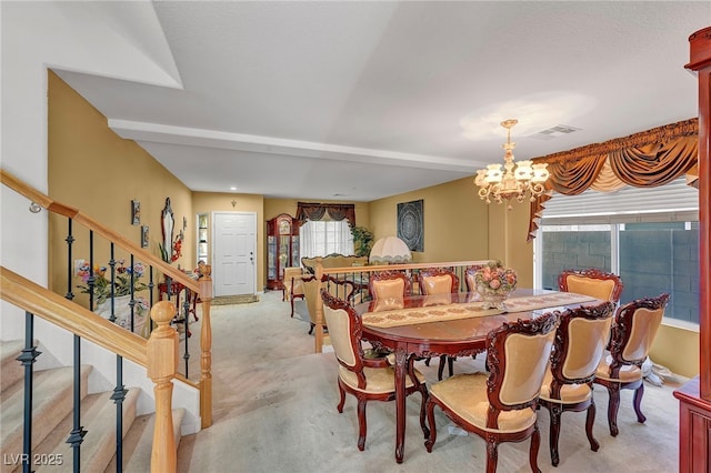 dining area featuring light carpet, stairway, a chandelier, and baseboards