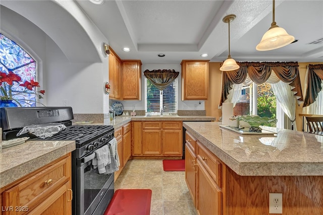kitchen with black gas stove, healthy amount of natural light, recessed lighting, and a tray ceiling