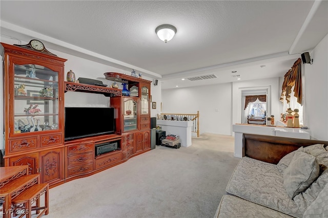 carpeted living room featuring a textured ceiling