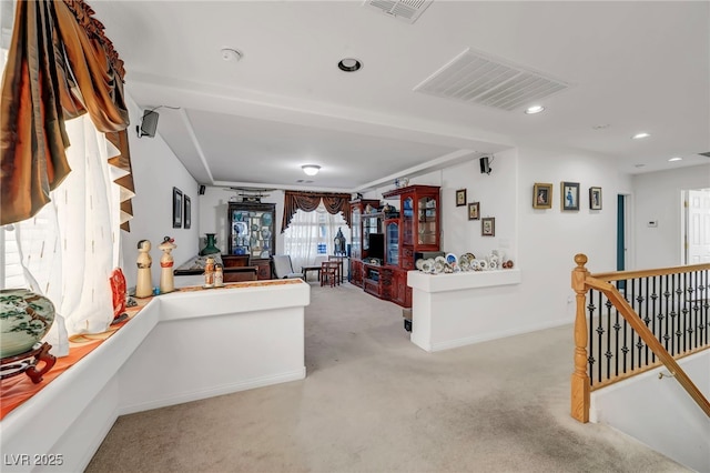 hallway with carpet, recessed lighting, baseboards, and an upstairs landing