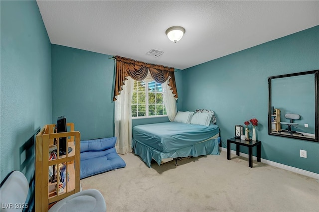 bedroom with carpet flooring, a textured ceiling, and baseboards