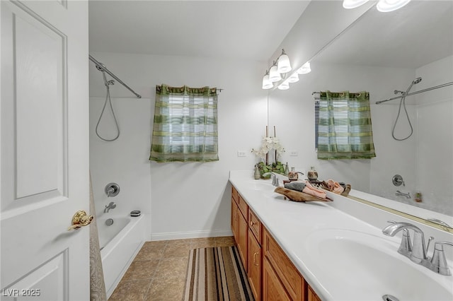 full bath with shower / tub combination, double vanity, and baseboards