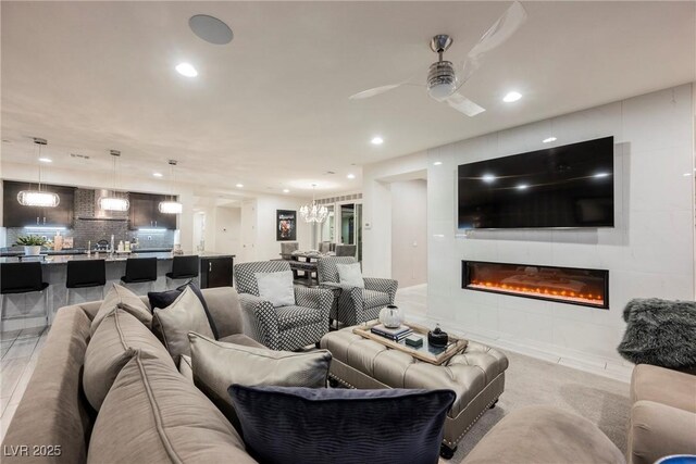 4576 Amazing View St, Las Vegas, NV 89129 - living room with recessed lighting, ceiling fan, a fireplace, and a chandelier
