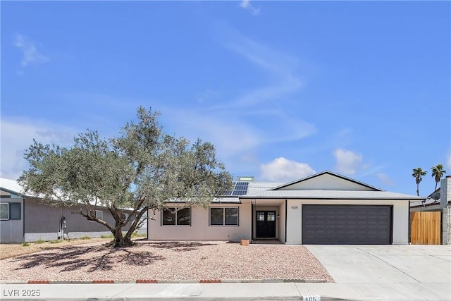 405 Oil Lantern Ln, Las Vegas, NV 89145 - ranch-style house featuring an attached garage, driveway, and solar panels