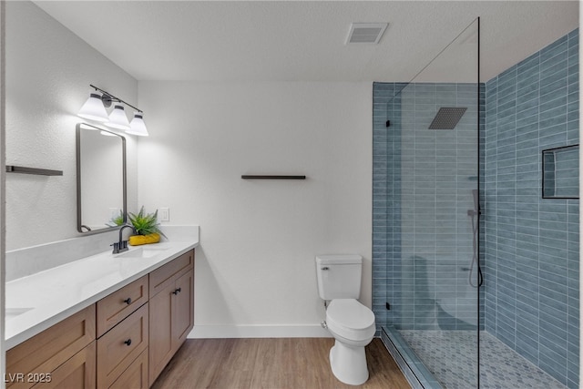 405 Oil Lantern Ln, Las Vegas, NV 89145 - bathroom featuring double vanity, tiled shower, wood finished floors, and toilet