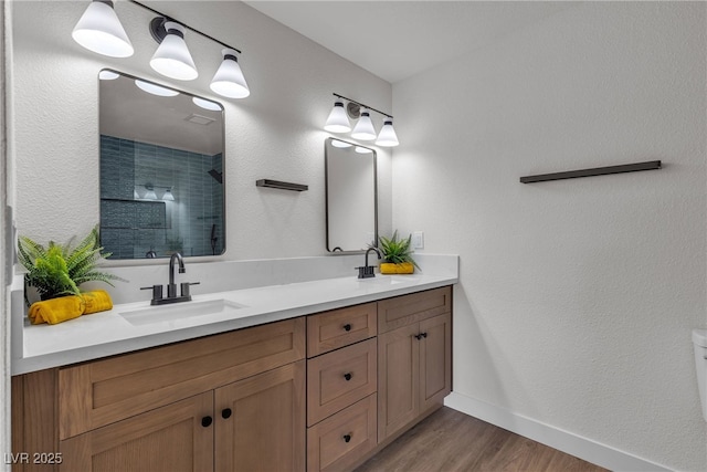405 Oil Lantern Ln, Las Vegas, NV 89145 - full bathroom featuring double vanity, a tile shower, wood finished floors, and baseboards