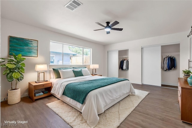 405 Oil Lantern Ln, Las Vegas, NV 89145 - bedroom featuring multiple closets, wood finished floors, a ceiling fan, and baseboards
