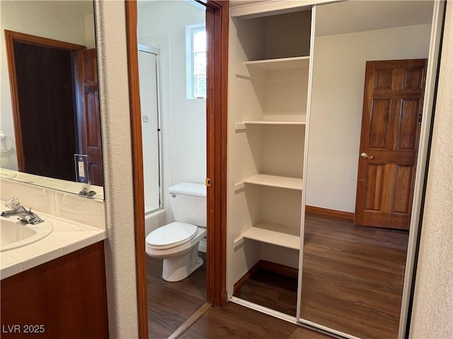 4455 W Ford Ave, Las Vegas, NV 89139 - bathroom with wood finished floors, an enclosed shower, and vanity