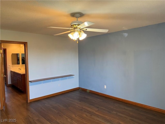 4455 W Ford Ave, Las Vegas, NV 89139 - empty room with ceiling fan and dark wood-type flooring