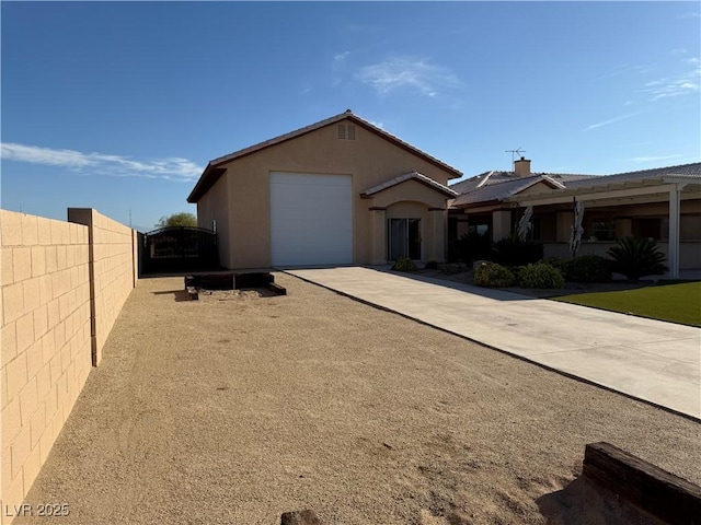 4455 W Ford Ave, Las Vegas, NV 89139 - view of front of house featuring a garage, concrete driveway, and stucco siding