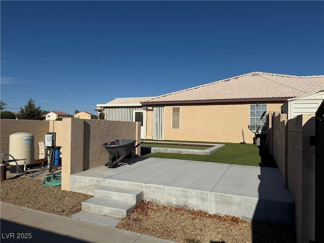 4455 W Ford Ave, Las Vegas, NV 89139 - view of home's exterior featuring a fenced backyard, a tiled roof, a patio area, and stucco siding
