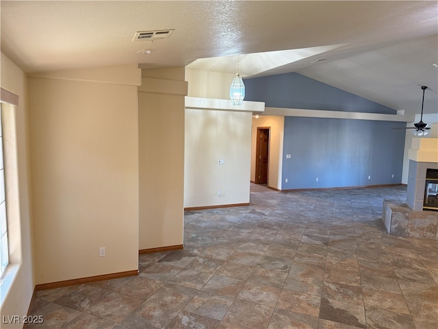 4455 W Ford Ave, Las Vegas, NV 89139 - unfurnished living room with lofted ceiling, a tiled fireplace, a ceiling fan, and stone finish flooring