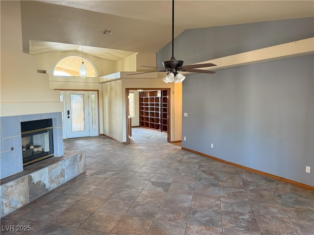 4455 W Ford Ave, Las Vegas, NV 89139 - unfurnished living room with vaulted ceiling, ceiling fan, stone finish floors, and a tile fireplace