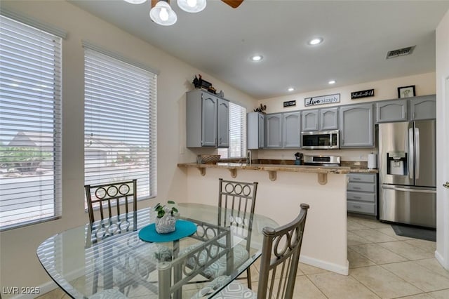 dining room featuring light tile patterned flooring, recessed lighting, and baseboards
