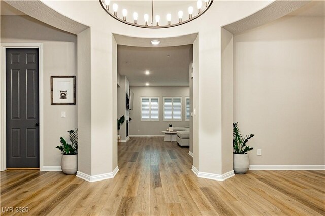 2450 Amatrice St, Henderson, NV 89044 - foyer entrance featuring wood finished floors, baseboards, and a chandelier