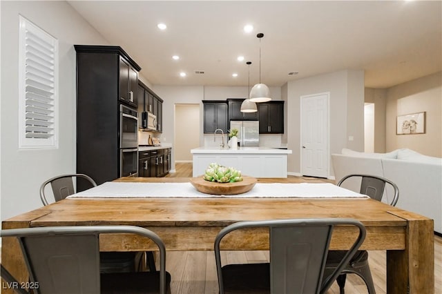 2450 Amatrice St, Henderson, NV 89044 - dining space with light wood-type flooring, recessed lighting, and baseboards