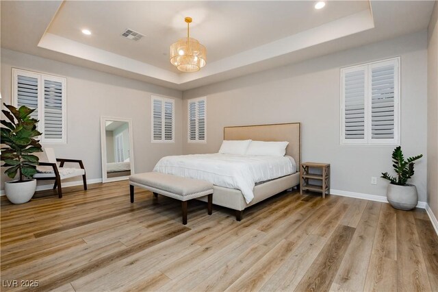 2450 Amatrice St, Henderson, NV 89044 - bedroom with a raised ceiling, light wood-style floors, baseboards, and recessed lighting