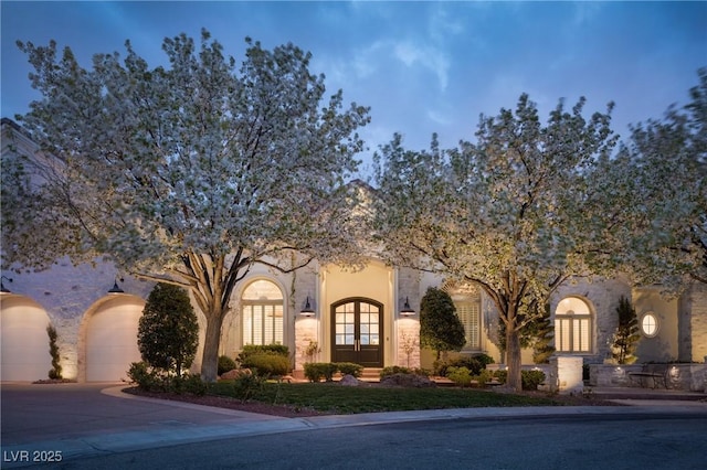 1610 Brock Ct, Las Vegas, NV 89117 - view of property hidden behind natural elements with concrete driveway, french doors, stucco siding, and an attached garage