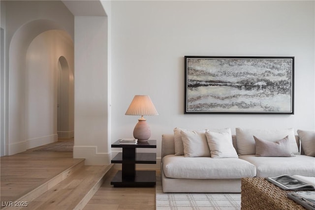 1610 Brock Ct, Las Vegas, NV 89117 - living area with arched walkways, light wood-style flooring, and baseboards