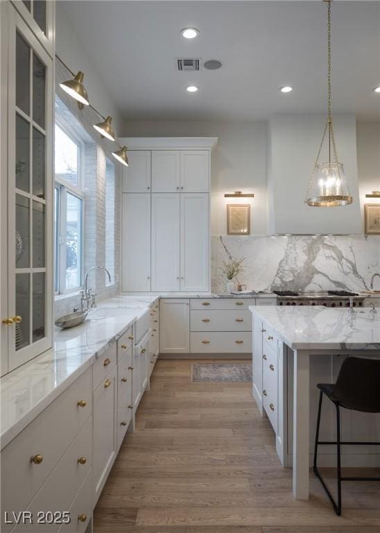 1610 Brock Ct, Las Vegas, NV 89117 - kitchen with a sink, white cabinetry, glass insert cabinets, and recessed lighting