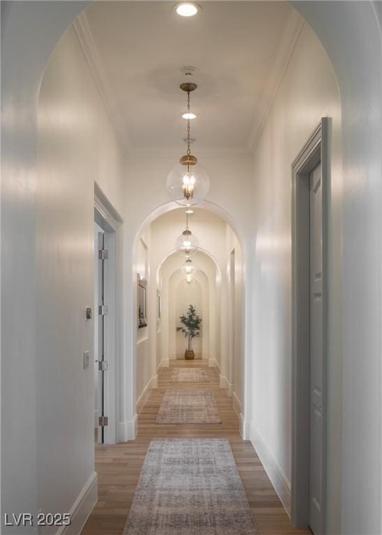 1610 Brock Ct, Las Vegas, NV 89117 - hall with arched walkways, ornamental molding, wood finished floors, and baseboards