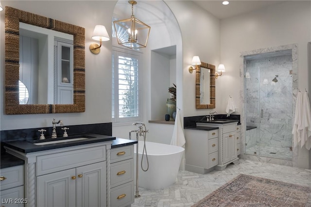 1610 Brock Ct, Las Vegas, NV 89117 - full bathroom featuring a shower stall, two vanities, a soaking tub, and recessed lighting