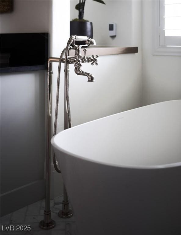 1610 Brock Ct, Las Vegas, NV 89117 - bathroom featuring a soaking tub and marble look tile flooring