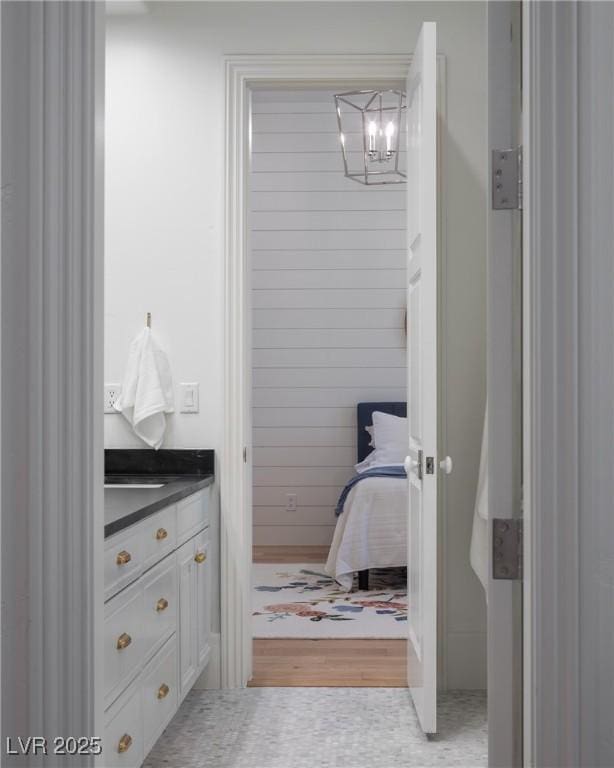 1610 Brock Ct, Las Vegas, NV 89117 - bathroom featuring a chandelier, vanity, and wood finished floors