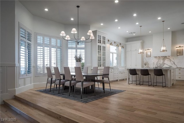 1610 Brock Ct, Las Vegas, NV 89117 - dining space with a chandelier, light wood finished floors, healthy amount of natural light, recessed lighting, and wainscoting
