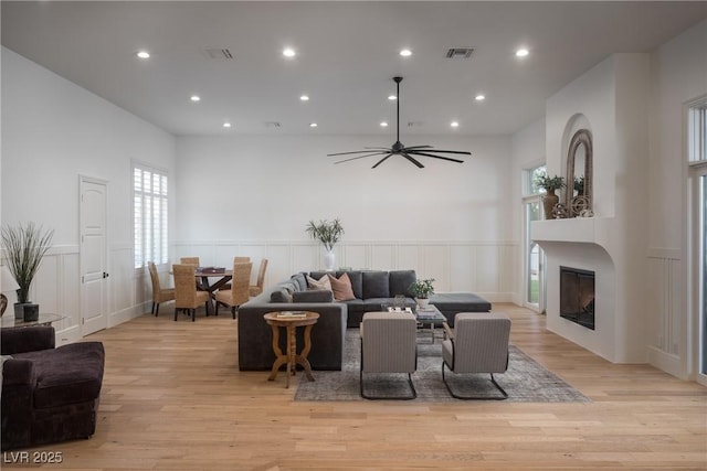 1610 Brock Ct, Las Vegas, NV 89117 - living room featuring a glass covered fireplace, light wood-type flooring, plenty of natural light, recessed lighting, and a decorative wall
