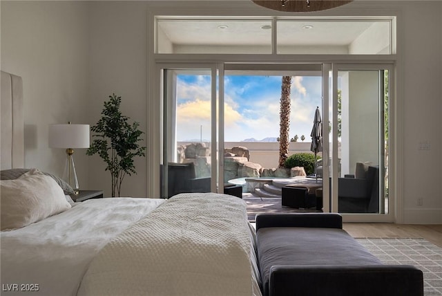 1610 Brock Ct, Las Vegas, NV 89117 - bedroom featuring access to exterior, wood finished floors, and multiple windows