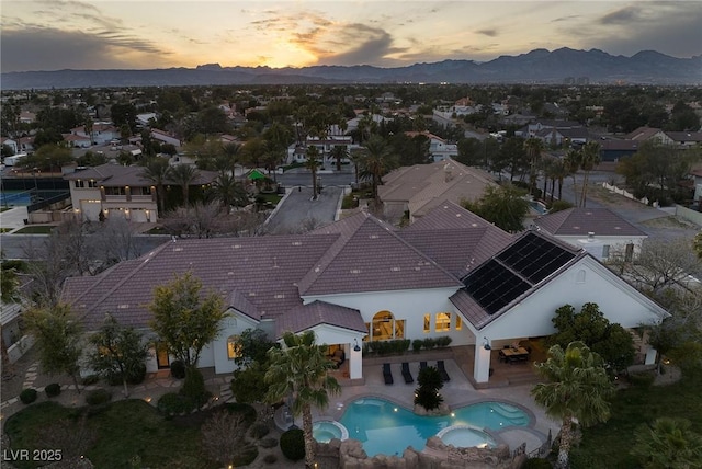 1610 Brock Ct, Las Vegas, NV 89117 - aerial view at dusk of a mountain view, view of pool area, and a residential view