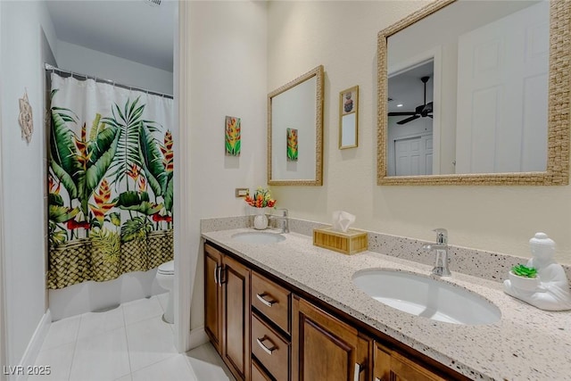 11477 Timber Mountain Ave, Las Vegas, NV 89135 - full bath featuring toilet, double vanity, tile patterned floors, ceiling fan, and a shower with curtain
