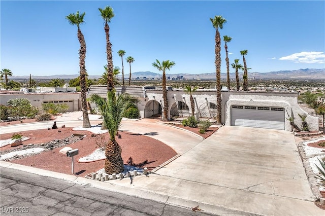 1157 Morning Sun Way, Las Vegas, NV 89110 - view of front of home featuring concrete driveway, a mountain view, a garage, and stucco siding