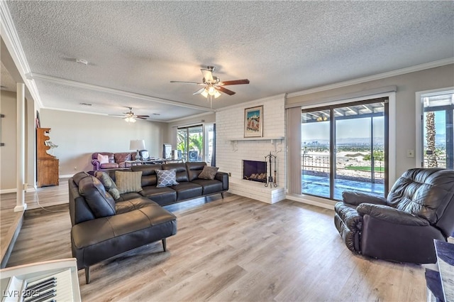 1157 Morning Sun Way, Las Vegas, NV 89110 - living area with ornamental molding, a textured ceiling, a fireplace, healthy amount of natural light, and ceiling fan