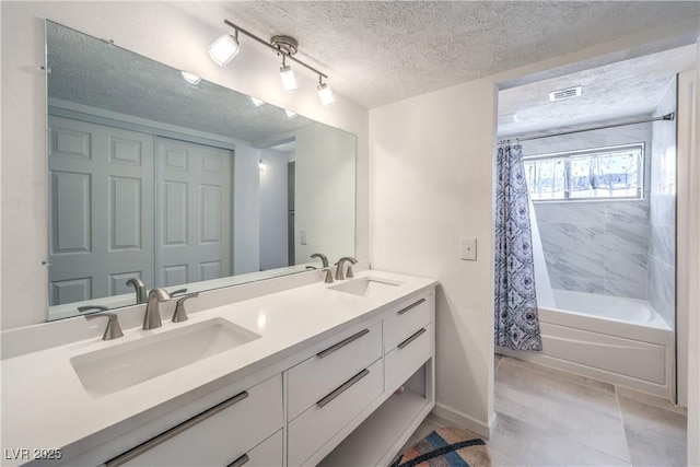 1157 Morning Sun Way, Las Vegas, NV 89110 - bathroom with a textured ceiling, double vanity, shower / bath combination with curtain, tile patterned floors, and baseboards