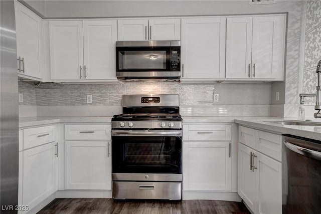 7905 Idledale Ct Unit 102, Las Vegas, NV 89145 - kitchen featuring appliances with stainless steel finishes, light countertops, and white cabinetry