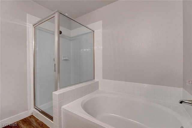7905 Idledale Ct Unit 102, Las Vegas, NV 89145 - bathroom featuring a shower stall, a garden tub, and wood finished floors