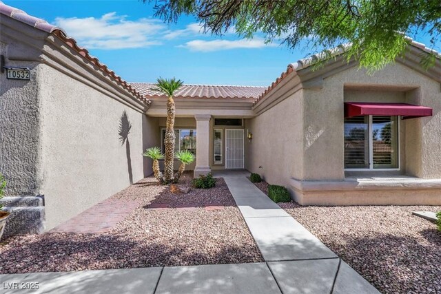 10532 Sea Palms Ave, Las Vegas, NV 89134 - doorway to property with stucco siding and a tile roof