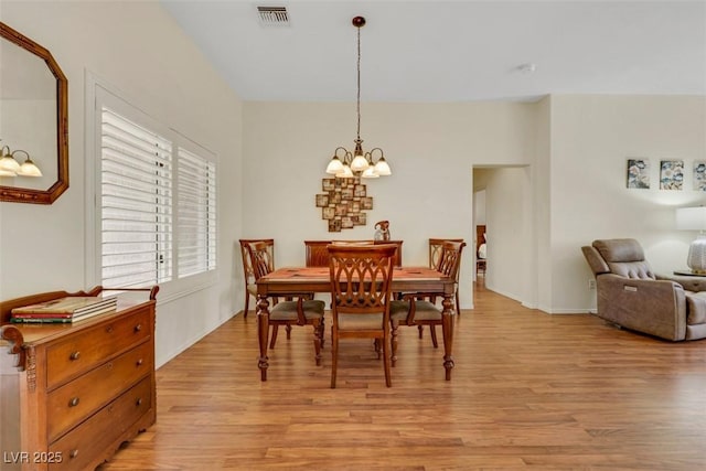 10532 Sea Palms Ave, Las Vegas, NV 89134 - dining area with a chandelier and light wood-style floors